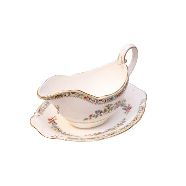 A traditional English bone china gravy boat and plate made in the Ming Rose pattern by Coalport China of Wedgwood,...