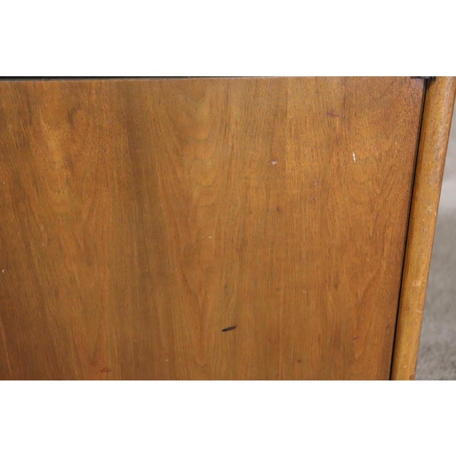 Pair of mid-century modern end tables with cabinet space. Walnut frames with metal door pulls.