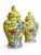 A vivid matching pair of lidded ginger jars with sunny yellow grounds and richly colored birds, flowering branches, and...