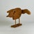 A delightful articulated Folk Art bird sculpture carved, cut, and assembled using light brown wood. The wings and the head...