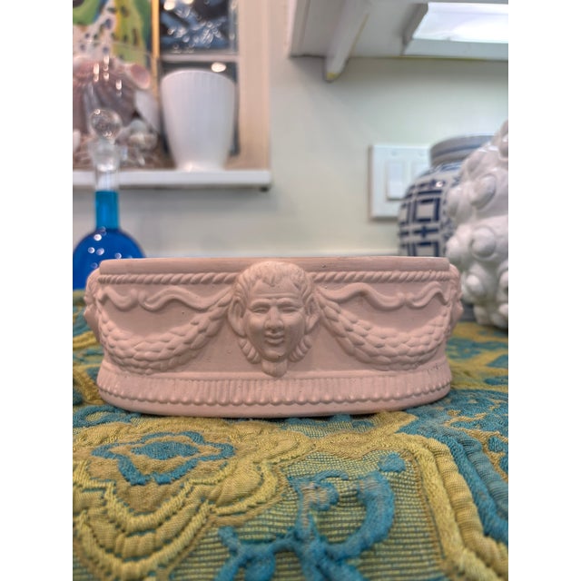 Vintage Neoclassical Terracotta Planter With Classical Faces A charming vintage terracotta planter with classical face...