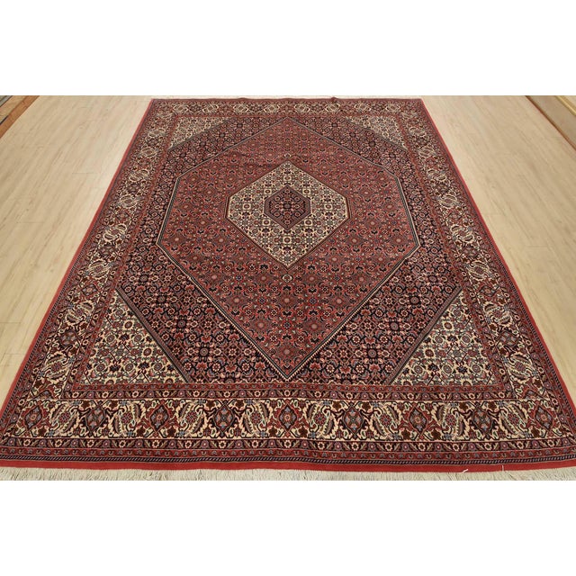 An authentic vintage traditional Bidjar rug hand-knotted with fine wool and natural dyes. This intricately woven rug...