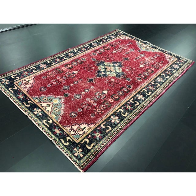 This is a vintage nomadic Turkish rug. The piece was handmade in the 1970s.