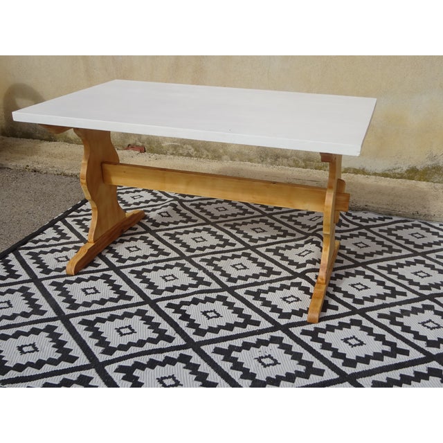 Pine dining table with monastery-style legs. The tabletop is painted white and protected with a colorless, water-...
