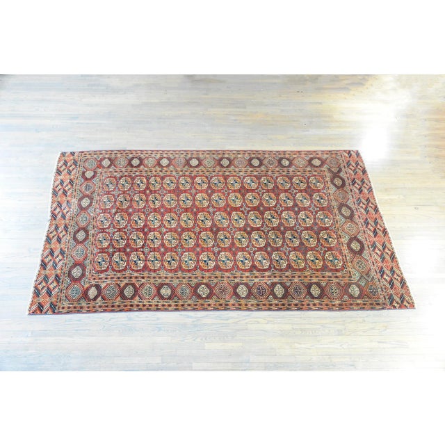 A wonderful early 20th century Persian Tekeh rug with an all-over pattern containing stylized floral medallions woven in...