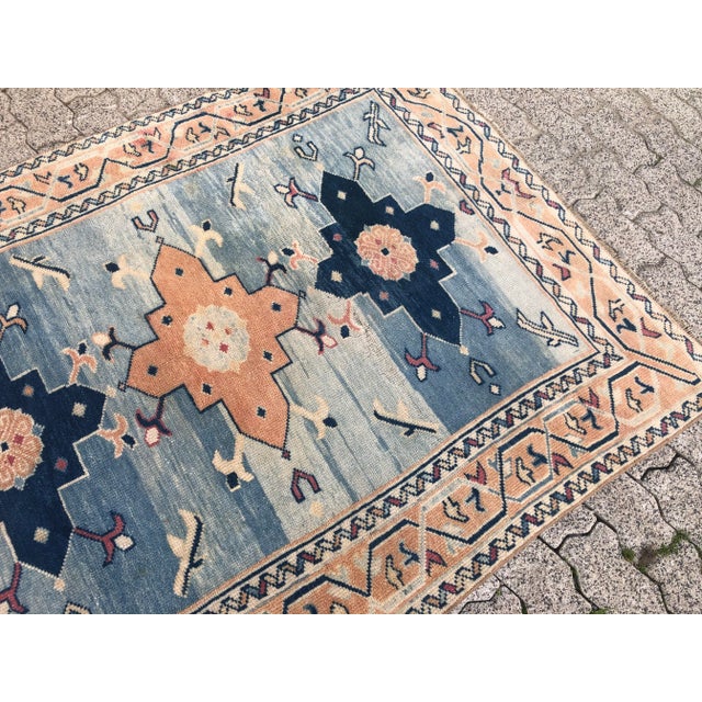 This is a vintage Turkish Oushak rug from the 1960s. The piece was hand-knotted.
