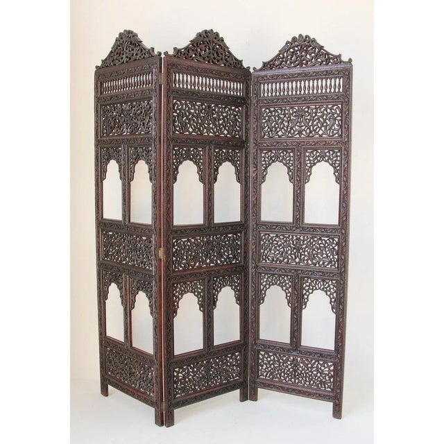 Anglo-Indian hardwood three-panel Screen. This is a beautifully carved sculptural hardwood Anglo-Indian Wooden Mughal...