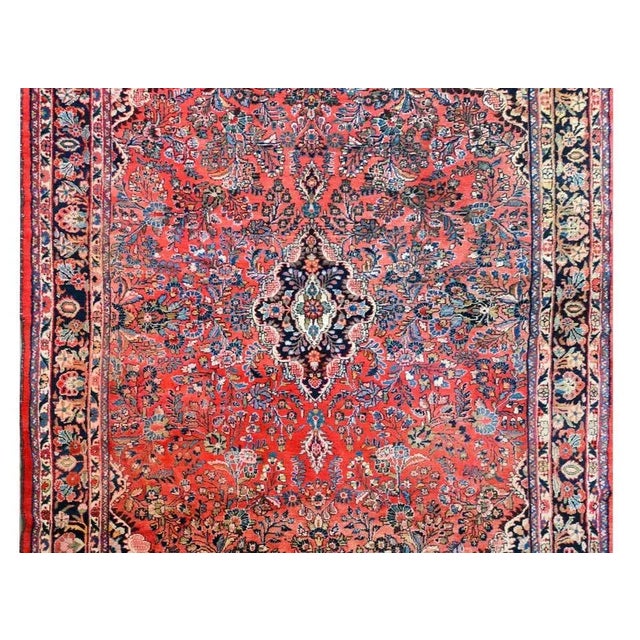 A beautiful early 20th century Persian Dargazin rug with a large central medallion against a dark indigo background...