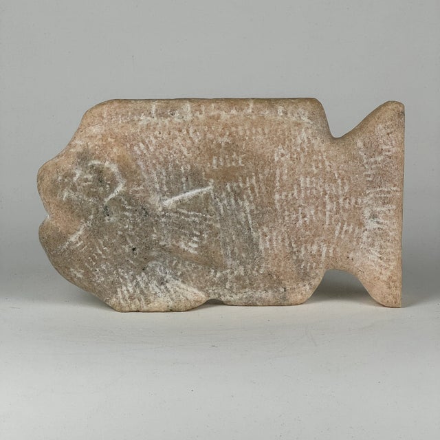 A joyful fish carved out of pinkish/golish colored stone. It free stands on its own and would make a gorgeous accent piece...