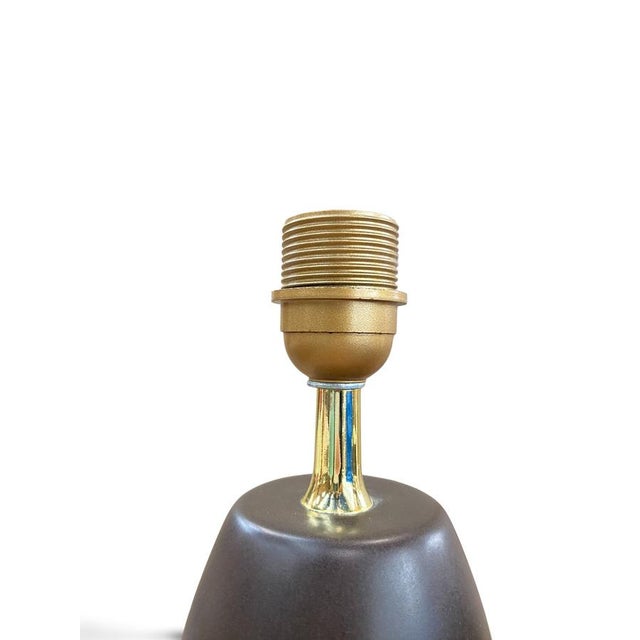 Pair of baluster-shaped lamp bases in deep red glazed ceramic with a glossy finish, topped with a gilt brass collar and an...