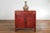 A small Chinese red lacquered wedding blanket chest from the 20th century, with gilt décor depicting guardian lions,...