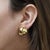 Roberto Coin 18K yellow gold clip-on earrings featuring an interlocked knot design with lever-back closure system. These...