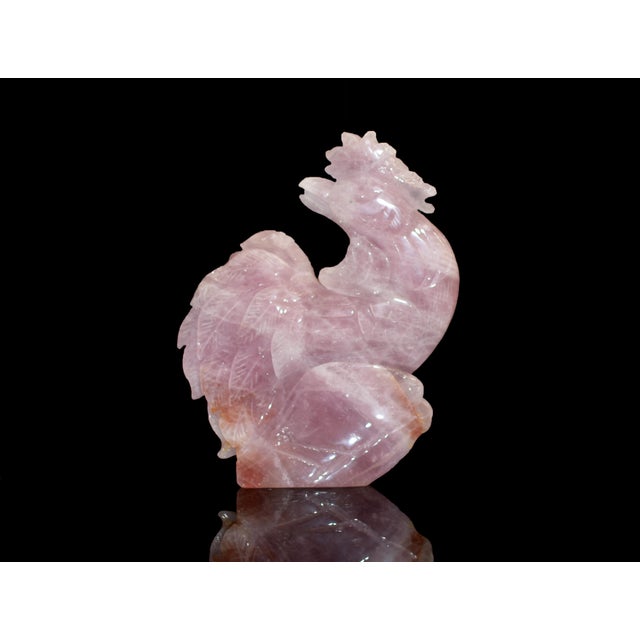 A charming and auspicious hand-carved rooster sculpted from natural rose quartz, beautifully polished to a soft, luminous...
