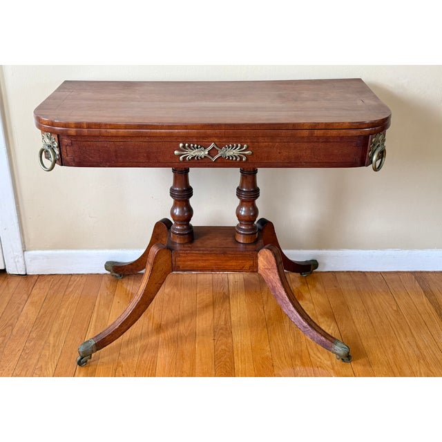 Antique flip-top convertible console to game table. The top can be rotated and flipped to reveal a felt-lined game...