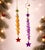 A whimsical pair of vintage glass icicle ornaments in vibrant yellow and purple hues. Each ornament features a charming...