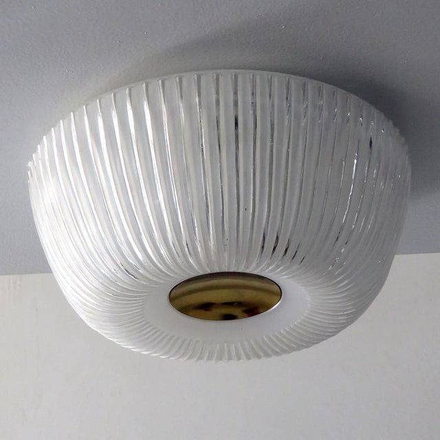 Elegant, textured glass ceiling flush mount by Doria Leuchten Germany with a circular brass center and organically shaped...