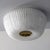 Elegant, textured glass ceiling flush mount by Doria Leuchten Germany with a circular brass center and organically shaped...