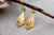 Gold earrings in the shape of an olive leaf with reliefs, articulated pendant and encrusted synthetic stones. Metal: Gold....