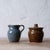 A Cleater Meaders creamer and a Whelchel Meaders sugar. Each signed with creamer dated 1988. sugar measures 4 inches wide...