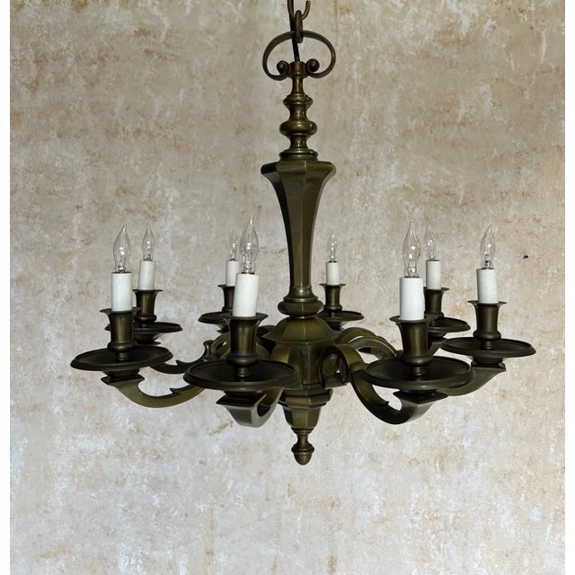 Elevate your space with this lovely French 1940s bronze chandelier, featuring eight ornate arms and a beautifully aged,...