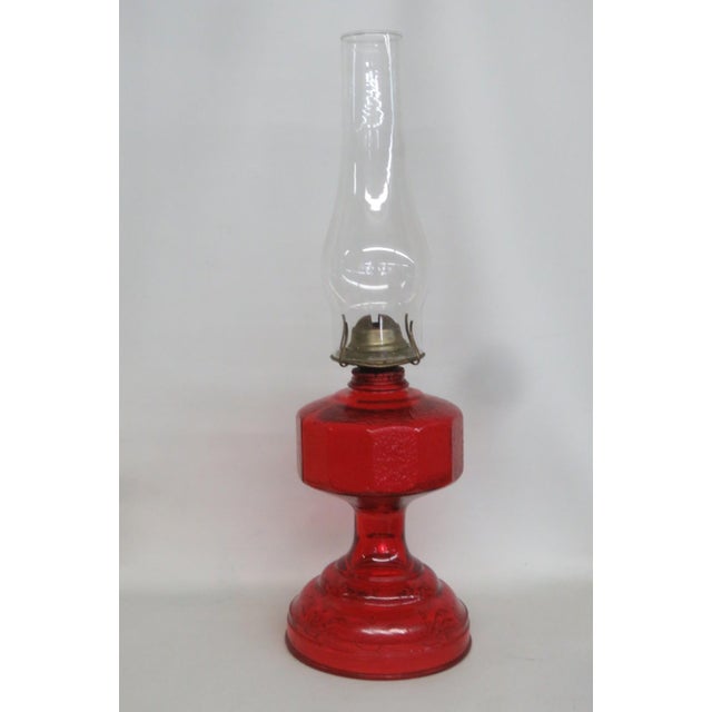 This beautiful Mid Century Oil Lamp is made of glass with a brass burner. The main body features a vibrant ruby red color...
