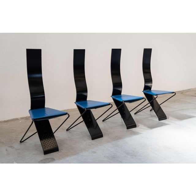 Chairs of the artist Pietro Arosio. High and curved chairs with back. Waped iron structure in black. Black -painted curved...