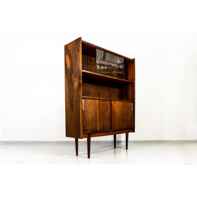 This mid-century display cabinet was produced in the 1960s by Bytomskie Fabryki Mebli, Poland as part of the “Syrius” type...