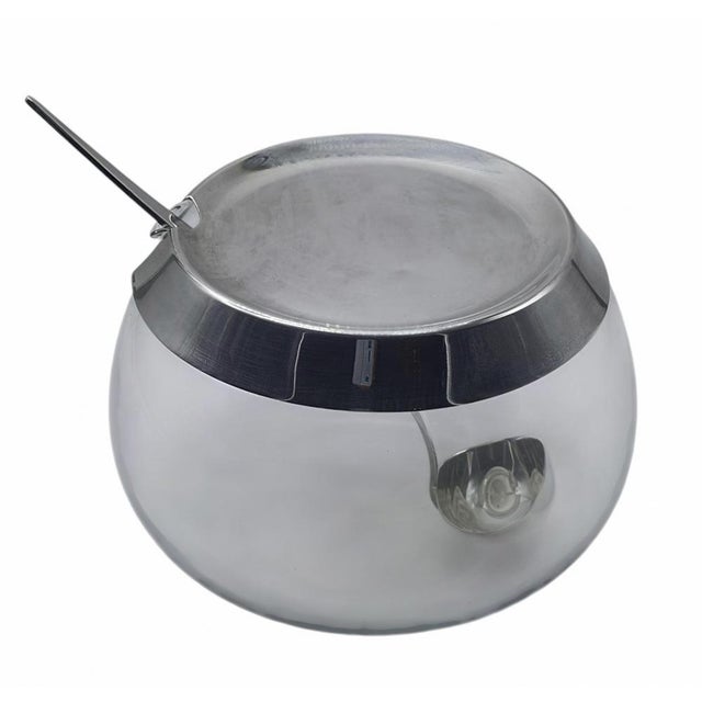 Cocktail container with a ladle, made of clear glass and silver-coloured metal, designed by Lino Sabattini in the...