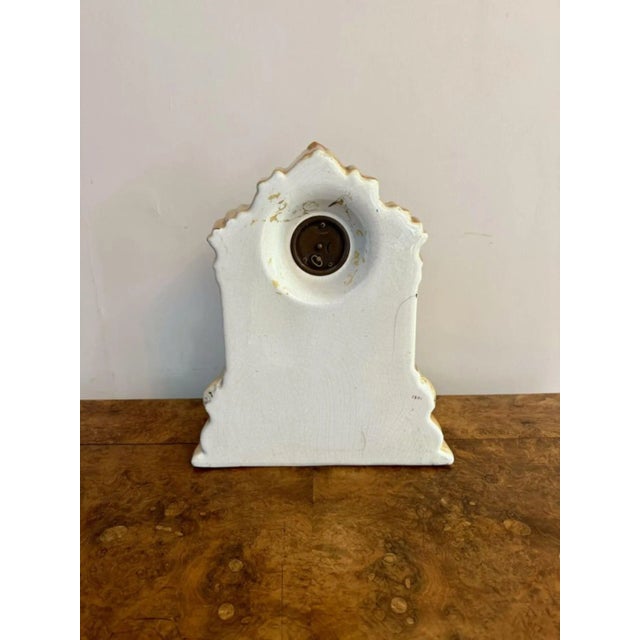 Pretty antique Staffordshire mantle clock, having an antique Staffordshire mantle clock decorated with fruits in vibrant...