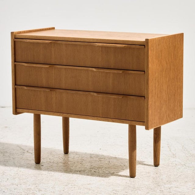 A fully restored oak nightstand with three drawers from the 1960s. The furniture has specially designed handles and...