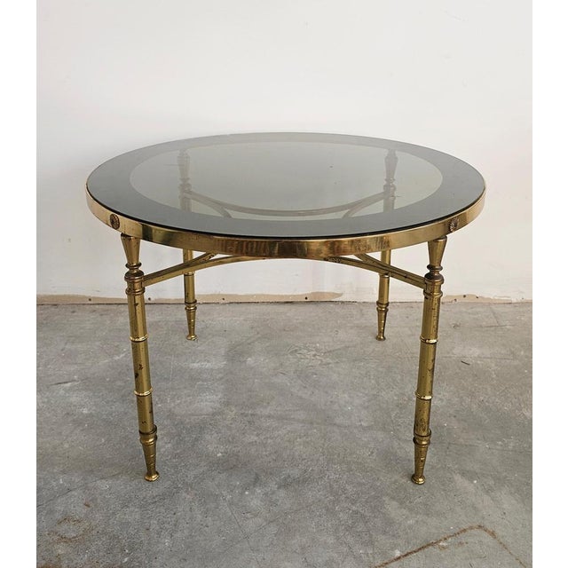 Here you can find a stunning Coffee or Side table done in gilt bronze, from the French Hollywood Regency era, designed by...