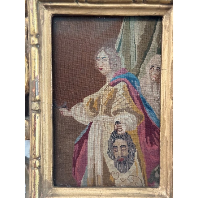 A charming vintage needlepoint tapestry depicting the biblical story of Judith and Holofernes, beautifully presented in an...