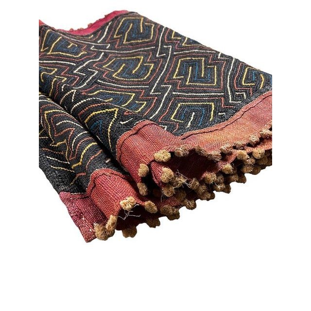 Kuba cloth, the result of a laborious process involving many hands, is one of the most famous cultural exports of this...