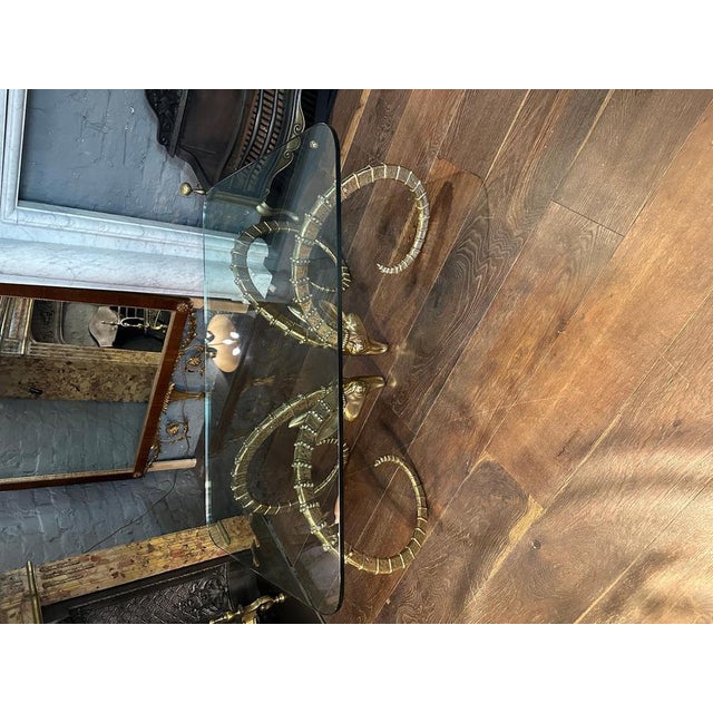 A substantial and very decorative coffee or cocktail table with two large opposing Ibex heads in very well cast brass. The...