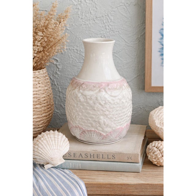 A vintage Belleek Ireland porcelain carafe from the sought-after “Neptune” pattern, featuring a glossy ivory neck and a...