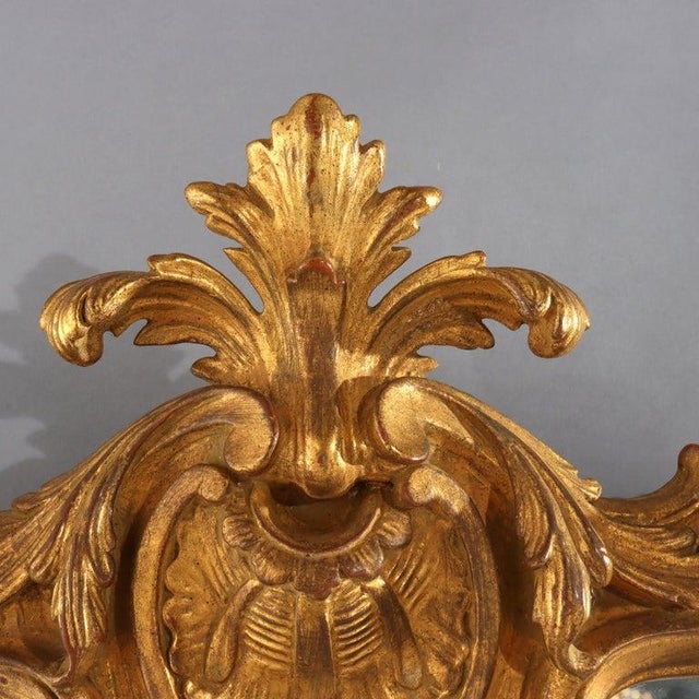 The antique French triptych mantle mirror, dating to approximately 1890, showcases the opulent Louis XIV Revival style....