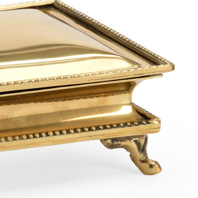 Large polished brass box with hinged lid and decorative trim.