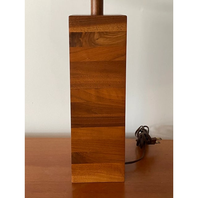 Stacked walnut table lamp designed by famed lamp makers Jane and Gordon Martz. Incredible wood grain creates a flowing...