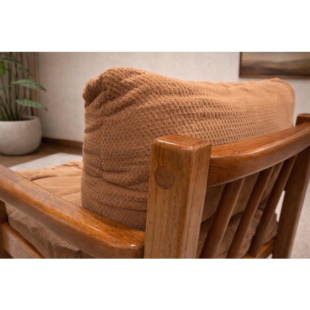 This mid-century modern lounge chair features a beautifully balanced design with clean lines, warm wood tones, and...