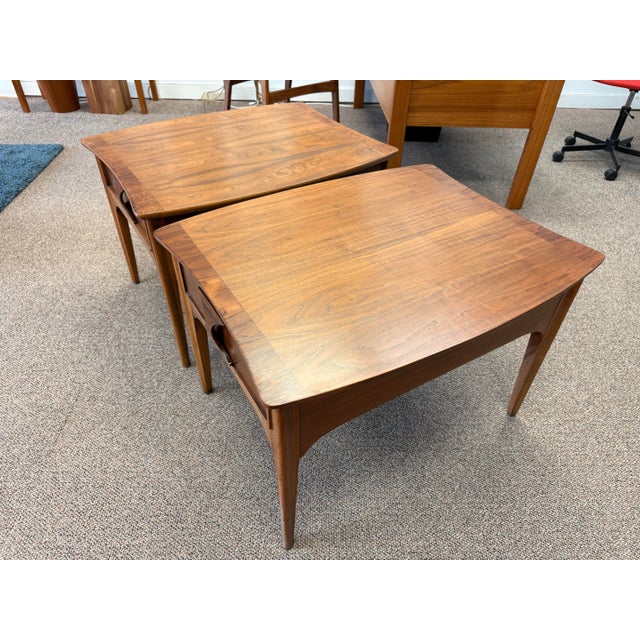 Pair of mid-century, modern walnut and Rosewood side tables by Kent Coffey. The tables are from the Perspecta collection...