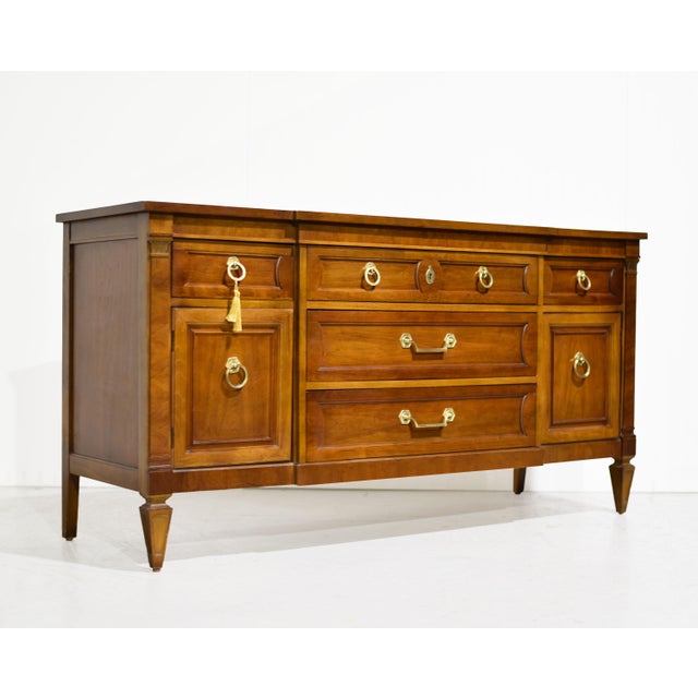 A timeless silhouette with endless possibilities, this mid century transitional credenza by Thomasville combines clean...