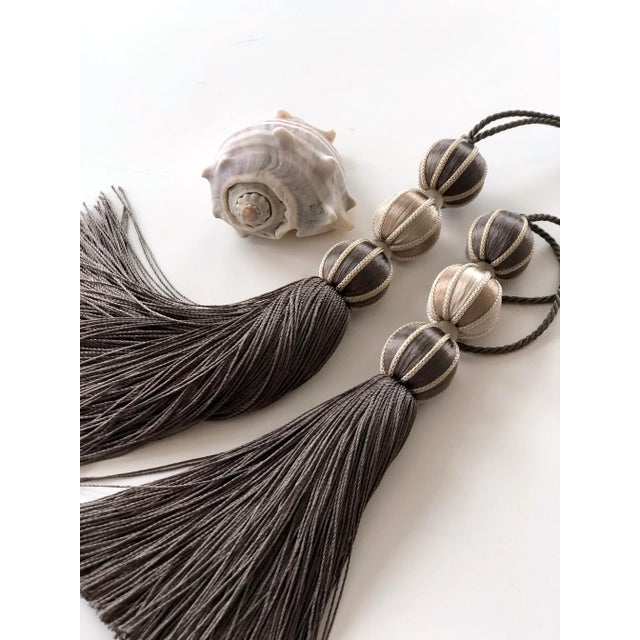 Handmade and styled for a modern twist on an Old World classic, these muted smoky ash and stone colored beaded Key Tassels...