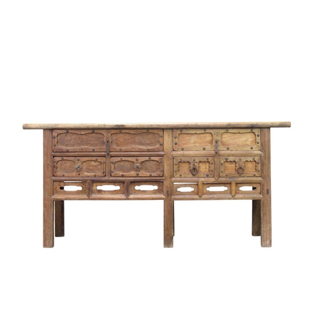 This early 19th century sideboard is handmade using sturdy elm and features a natural, honey toned finish. It is designed...