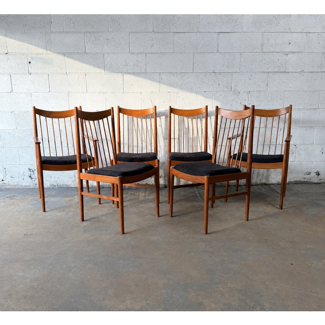A set of six teak dining chairs designed by Arne Vodder for Sibast, including four side chairs and two armchairs. The...