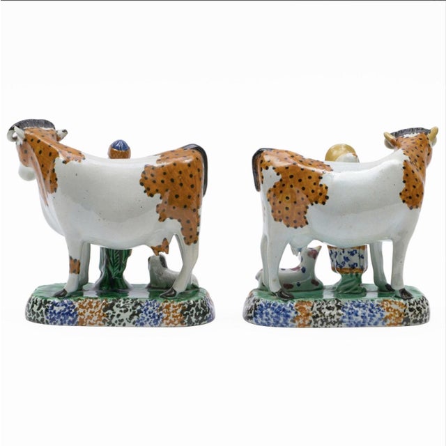 English Prattware Figures of Cows with Attendants, Yorkshire, Early 19th Century, This is a charming and characterful pair...