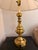 An exceptional Mid-Century Modern solid brass table lamp. This elegant luminary features signature Hollywood Regency...