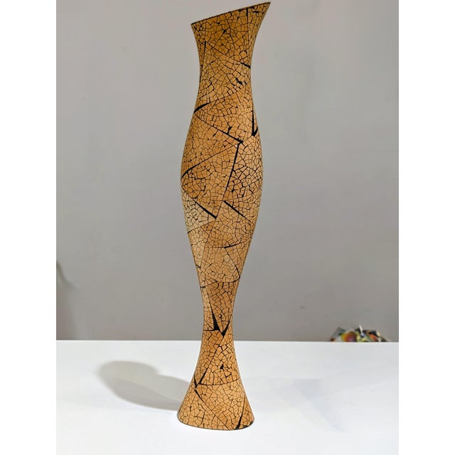 This tall sculptural vase, attributed to R & Y Augousti, features a distinctive eggshell lacquer (coquille d’oeuf) finish....