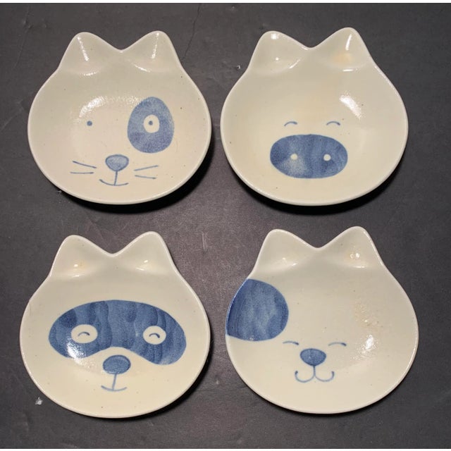 Set of 4 elegant, mid century modern, sushi plates in the form of cats faces, by Kotobuki. Each plate features a different...