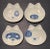 Set of 4 elegant, mid century modern, sushi plates in the form of cats faces, by Kotobuki. Each plate features a different...