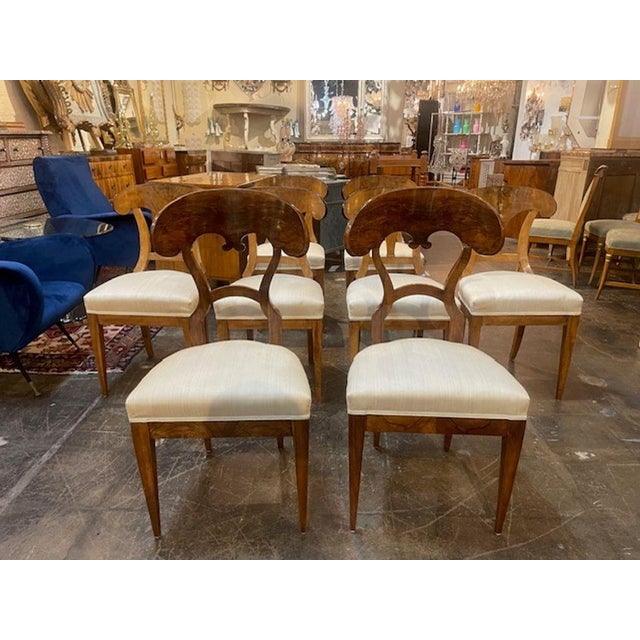 This set of 8 Biedermeier walnut dining chairs are made from high-quality walnut wood. These chairs feature a sleek and...